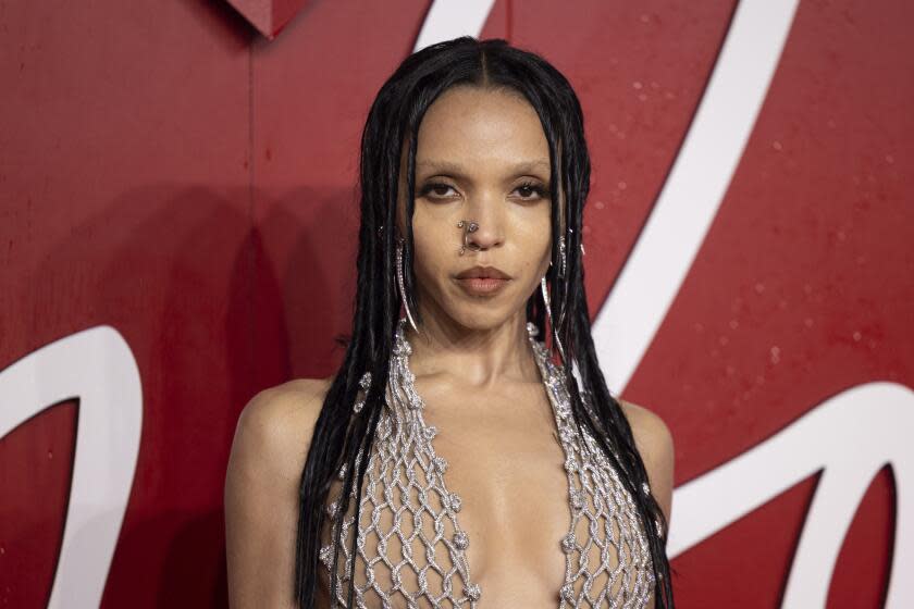 FKA Twigs poses for photographers upon arrival at the British Fashion Awards on Monday, Dec. 4, 2023 in London. (Vianney Le Caer/Invision/AP)