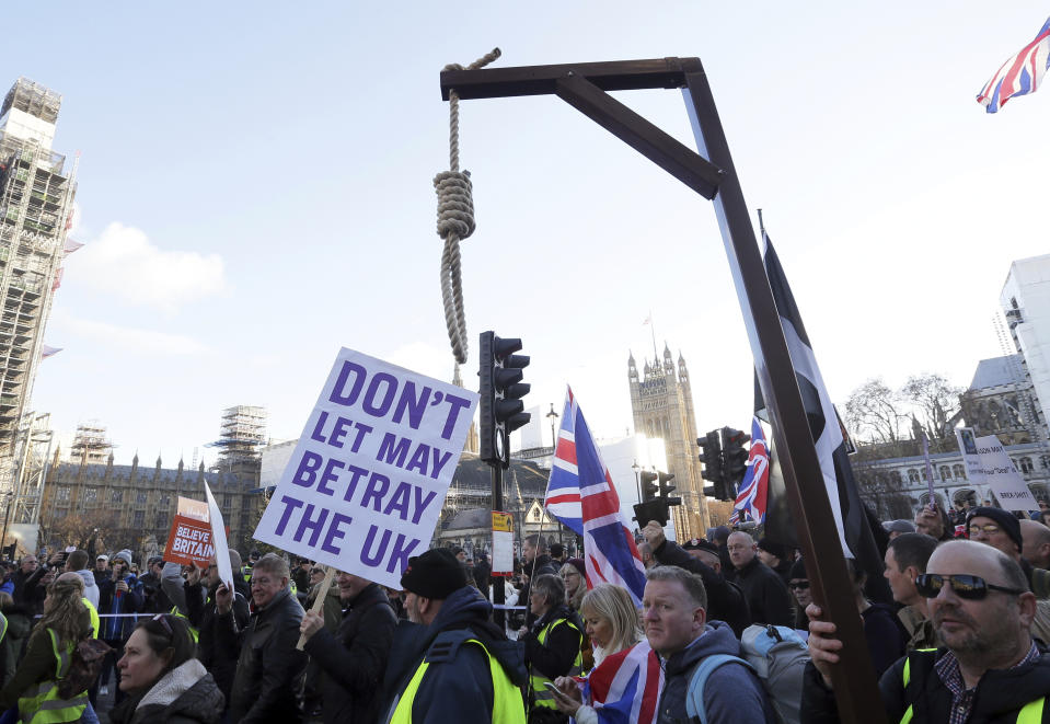 Demonstrators hold placards at the "Brexit Betrayal Rally", a pro-Brexit rally, on Park Lane in London, Sunday Dec, 9, 2018. MP's are to vote on the EU withdrawal agreement on Tuesday. (AP Photo/Tim Ireland)