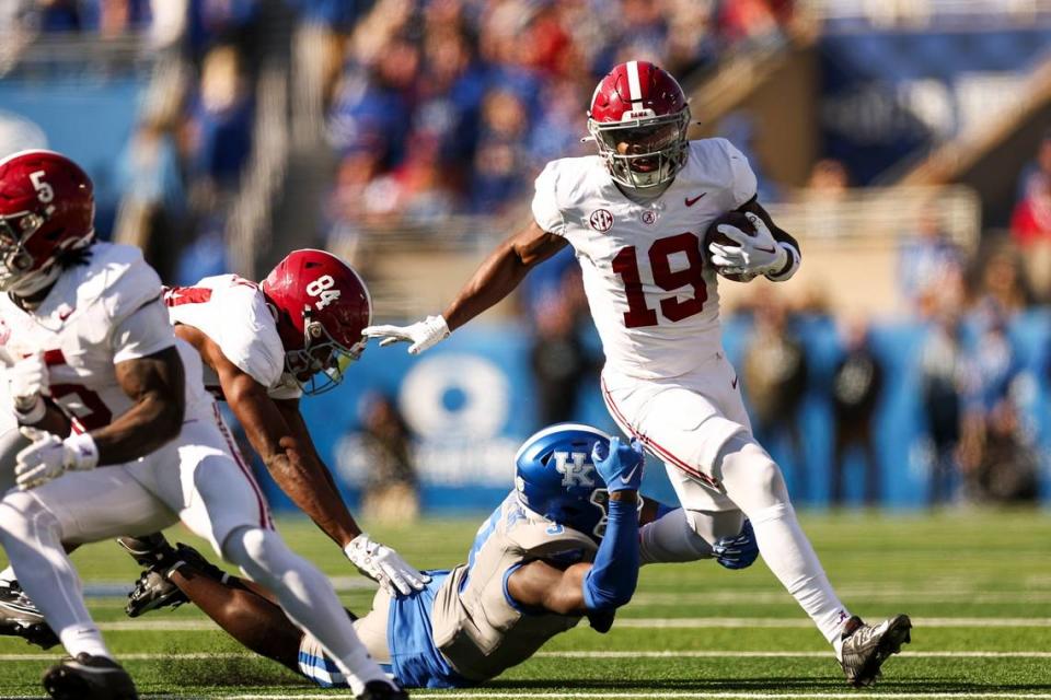 Alabama wide receiver Kendrick Law (19) tries to elude a tackle by Kentucky’s Alex Afari (3) during the first half at Kroger Field on Saturday.