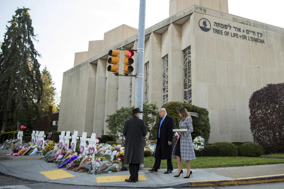 FILE - In this Oct. 30, 2018 file photo, Tree of Life Rabbi Jeffrey Myers, left, walks President Donald Trump and first lady Melania Trump to a memorial outside for those killed the previous Saturday at the Tree of Life Synagogue in Pittsburgh. Before a suspect was even publicly named, the president declared that whoever gunned down 11 people at the synagogue should "suffer the ultimate price" and that the death penalty should be brought back "into vogue." (AP Photo/Andrew Harnik, File)