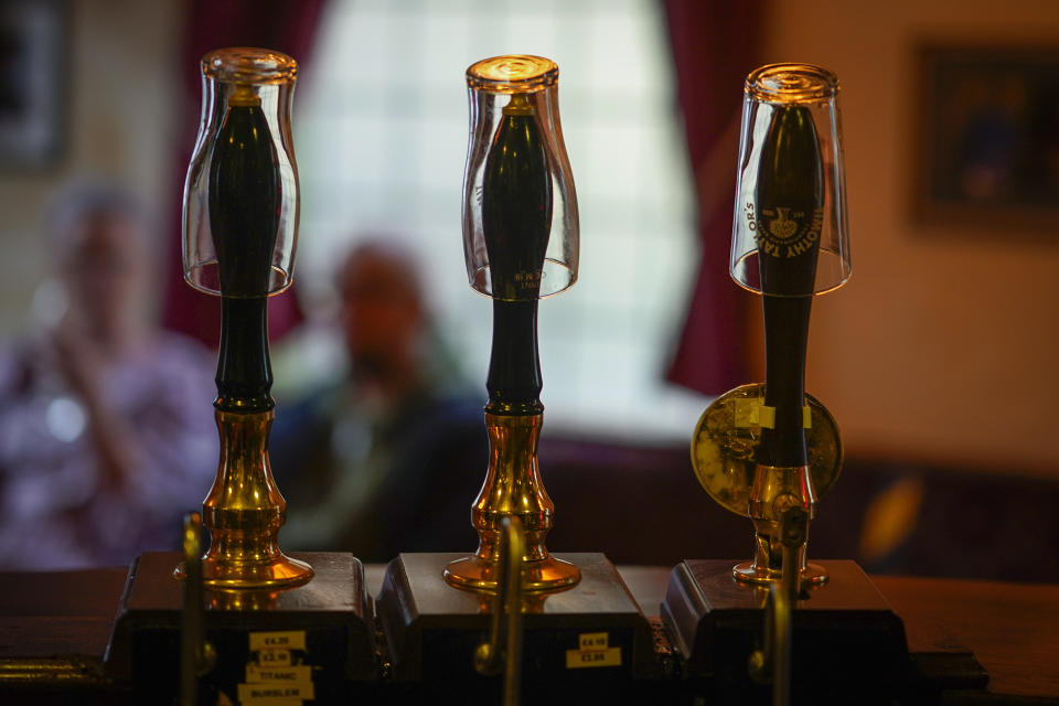 MANCHESTER, ENGLAND - OCTOBER 22: Empty pint glasses sit on the top of beer pumps of the Peveril Of The Peak pub, signifying they have been disconnected from the barrels ahead of new Tier-3 Covid-19 restrictions on October 22, 2020 in Manchester, England. Greater Manchester moves into the government's tier 3, high coronavirus alert level at midnight forcing the closure of pubs not serving substantial meals.  (Photo by Christopher Furlong/Getty Images)