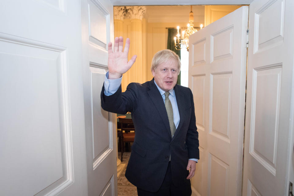 Prime Minister Boris Johnson is greeted by staff as he arrives back at 10 Downing Street, London, after meeting Queen Elizabeth II and accepting her invitation to form a new government after the Conservative Party was returned to power in the General Election with an increased majority.