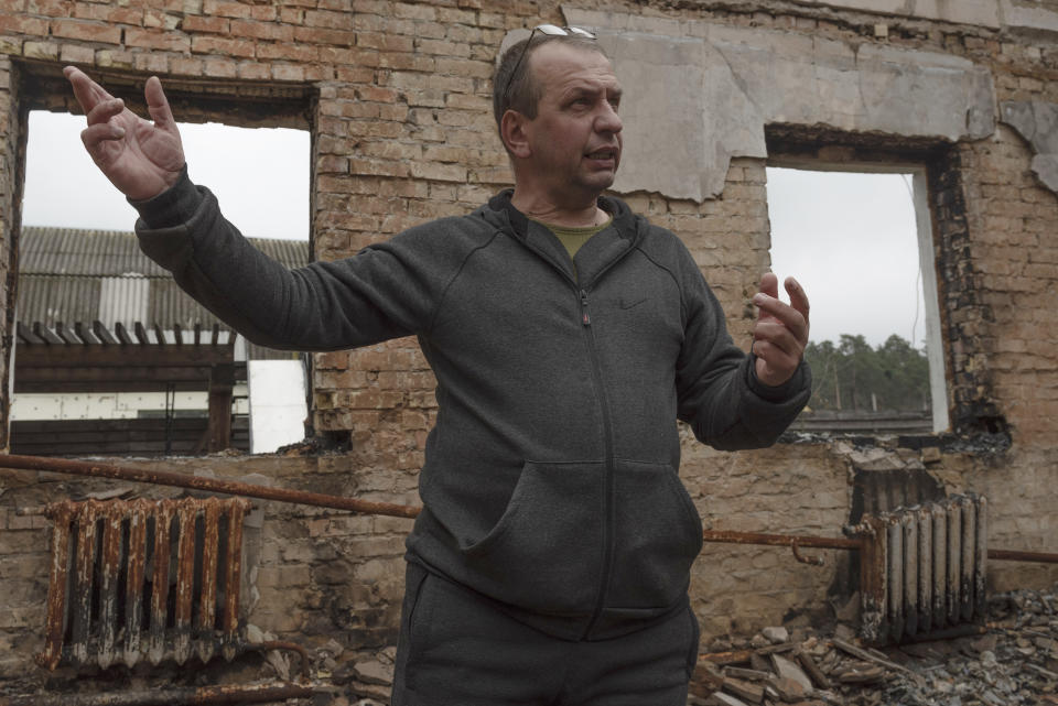 Vadym Zherdetsky talks to The Associated Press amid the wreckage of his house destroyed by fighting, in the village of Moshun, outside Kyiv, Ukraine, Friday, Nov. 4, 2022. (AP Photo/Andrew Kravchenko)