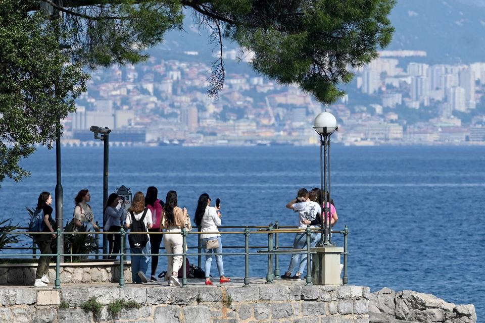 Tourists take pictures in Opatija, on the northern coast of the Adriatic Sea in western Croatia