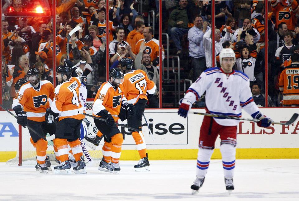 Philadelphia Flyers' Wayne Simmonds, second from right, celebrates his hat trick with teammates during the second period in Game 6 of an NHL hockey first-round playoff series against the New York Rangers, Tuesday, April 29, 2014, in Philadelphia. (AP Photo/Chris Szagola)
