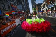 A reveler walks in a dress during the" WorldPride" gay pride Parade in Toronto, June 29, 2014. Toronto is hosting WorldPride, a week-long event that celebrates the lesbian, gay, bisexual and transgender (LGBT) community. REUTERS/Mark Blinch (CANADA - Tags: SOCIETY)