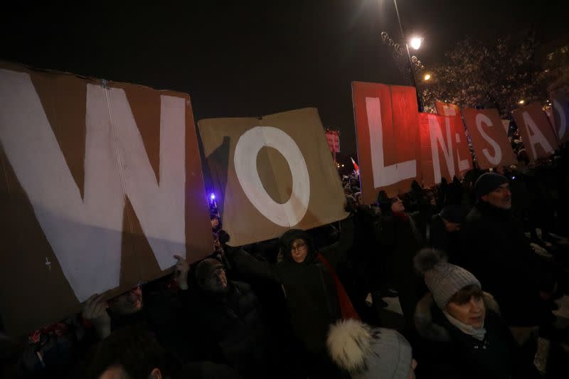 People take part in an anti-government protest in support of free judiciary in Warsaw