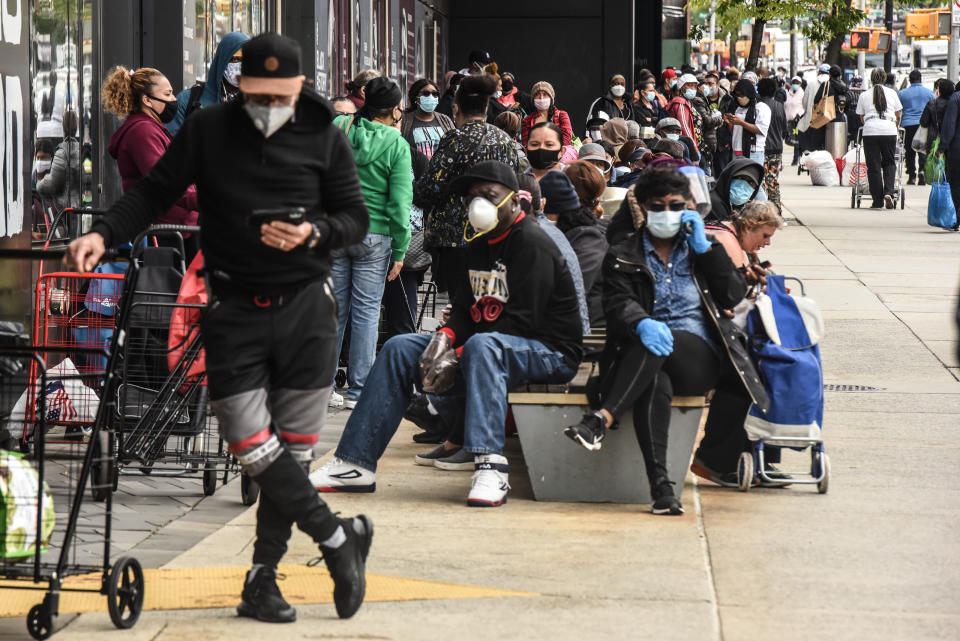 People wait on a long line to receive a food bank donation at the Barclays Center on May 15, 2020 in the Brooklyn borough in New York City. The event was organized by Food Bank for New York City and included dairy and meat items. (Stephanie Keith/Getty Images)