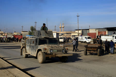 Military vehicles of the Iraqi army take part in an operation against Islamic State militants in Gogjali neighborhood in Mosul, Iraq, December 4, 2016. REUTERS/Thaier Al-Sudani