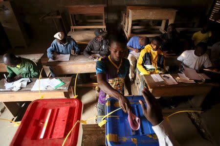 A man casts his vote during the second round of presidential and legislative elections in the mostly Muslim PK5 neighbourhood of Bangui, Central African Republic, February 14, 2016. REUTERS/Siegfried Modola