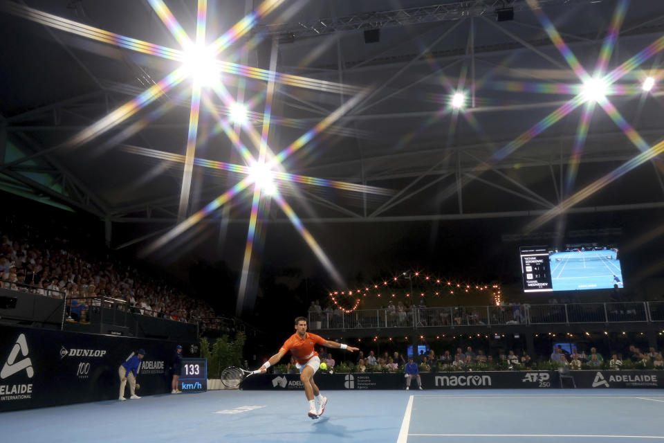 Serbia's Novak Djokovic makes a forehand return to Russia's Daniil Medvedev in the semi final match at the Adelaide International Tennis tournament in Adelaide, Australia, Saturday, Jan. 7, 2023. (AP Photo/Kelly Barnes)