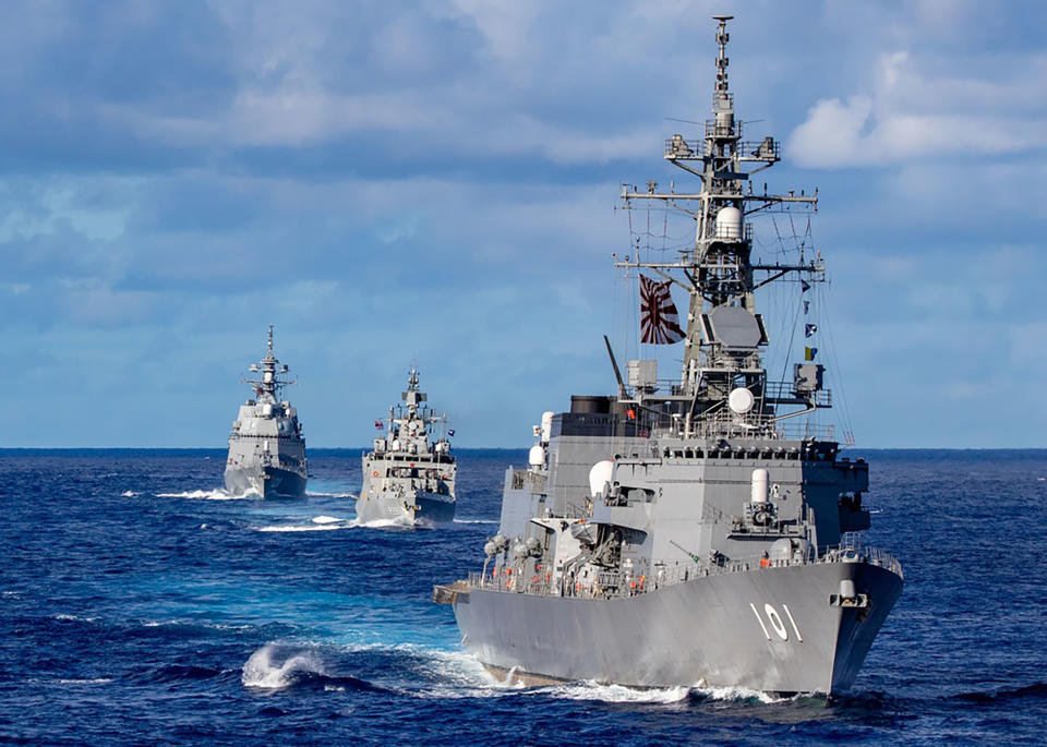 FILE- In this photo released by Defense Visual Information Distribution Service, ships from Japan Maritime Self-Defense Force and Indian Navy sail in formation with Royal Australian Navy HMAS Warramunga and Arleigh Burke-class guided-missile destroyer USS Barry (DDG 52) during MALABAR 2021 on Aug. 27, 2021. India, along with the U.S., Australia and Japan as part of the Indo-Pacific strategic alliance known as the Quad, have repeatedly accused China of flexing its military muscle in South China Sea and becoming increasingly aggressive by pushing claims to disputed maritime zones. The navies of the four countries have regularly held naval drills seen as part of a regional initiative to counter China's growing assertiveness in the Pacific. (Justin Stack/DVIDS U.S. Navy via AP)