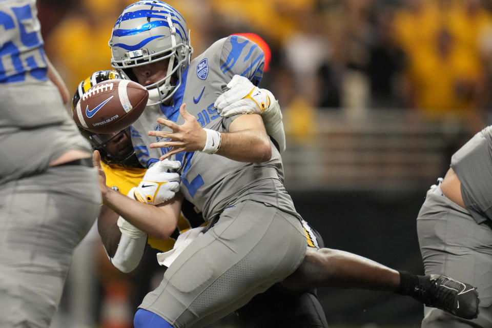 Memphis quarterback Seth Henigan fumbles as he is hit by Missouri defensive lineman Johnny Walker Jr. during the second half of an NCAA college football game Saturday, Sept. 23, 2023, in St. Louis. Memphis recovered the fumble. (AP Photo/Jeff Roberson)