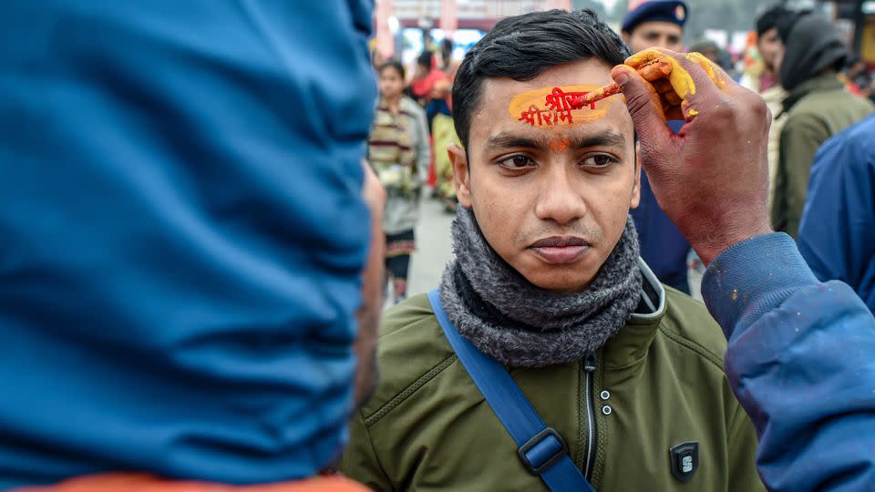 A devotee gets anoint the name of Lord Ram on his forehead ahead of the Inauguration of the Ram Mandir Temple on January 20, 2024 in Ayodhya, India. - Ritesh Shukla/Getty Images
