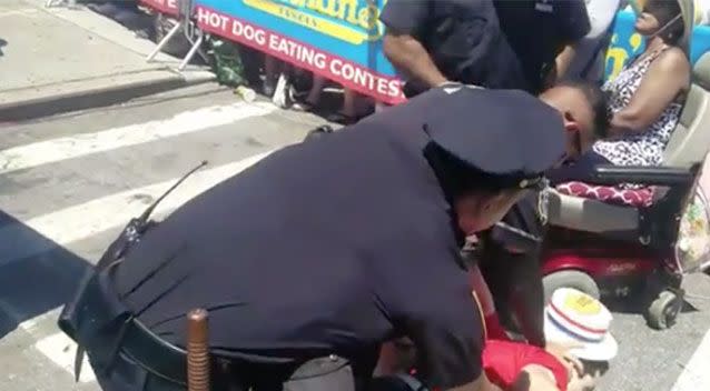 An animal rights activist is arrested at the Nathan's Hot Dog eating contest on Coney Island. Source: Big Cat/Twitter