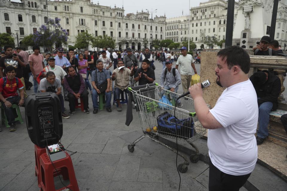 In this Dec. 13, 2019 photo, congressional candidate Bryan Russell campaigns at San Martin Plaza in Lima, Peru. Russell, who has Down syndrome, is a candidate for Peru-Nacion, a center-right party that is not widely known in Peru, but his bold campaign ahead of the Jan. 26 parliamentary elections is getting attention. (AP Photo/Martin Mejia)