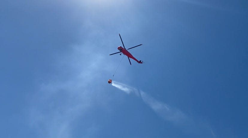 June 27, 2022: A third-party helicopter carries water to the 80-acre High Desert waste pit of Synagro Technologies Inc. as an entrenched fire hits one month.