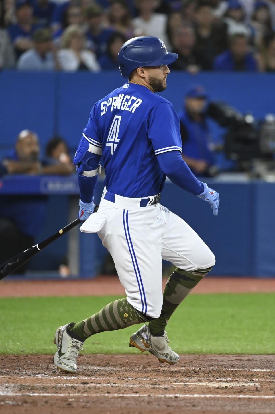 Toronto Blue Jays' George Springer watches his RBI single against the Cincinnati Reds during the fifth inning of a baseball game Friday, May 20, 2022, in Toronto. (Jon Blacker/The Canadian Press via AP)