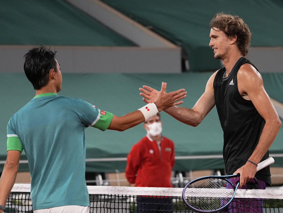 Germany's Alexander Zverev, right, shakes hands with Japan's Kei Nishikori, after he defeated him in their fourth round match on day 8, of the French Open tennis tournament at Roland Garros in Paris, France, Sunday, June 6, 2021. (AP Photo/Michel Euler)