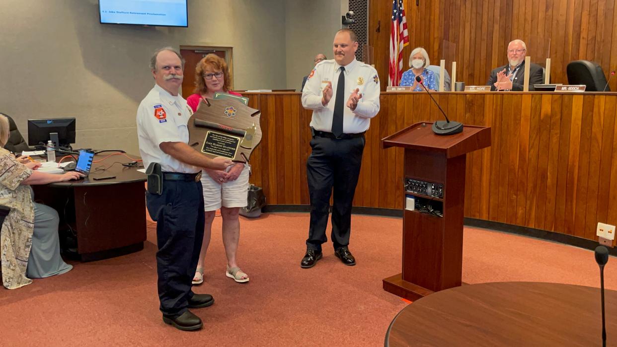 Jake Stafford holds a plaque honoring his years of service at the Aug. 8 Oak Ridge City Council meeting. Joining him, from left, are Dawn Stafford, Oak Ridge Fire Chief Travis Solomon and seated, Oak Ridge City Council members Ellen Smith and Chuck Hope.