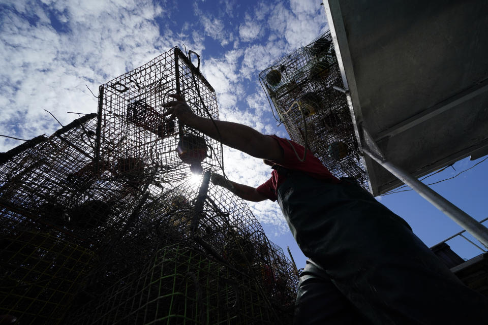 Jule Chaisson pulls his crab traps from Bayou Dularge in anticipation of Hurricane Delta, expected to arrive along the Gulf Coast later this week, in Theriot, La., Wednesday, Oct. 7, 2020. He said he's pulled around 1,000 traps over the last three days. (AP Photo/Gerald Herbert)