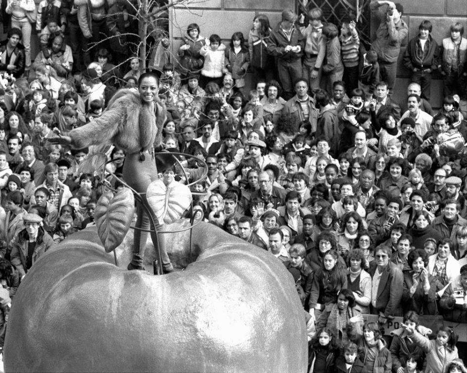 UNITED STATES - NOVEMBER 22:  Singer Diana Ross greets holiday crowd at the 53d annual Macy's Thanksgiving Day parade from atop The Daily News' Big Apple float down Broadway with its floats and hoopla and enough giant helium balloons to set a yougster's heart thumping. Balmy weather with the temperature up into the 60s produced a larger turnout than usual, with youngsters of all ages lining the parade route, 25 deep in some places. So many eager parade watches filled the sidewsalks and overflowed into the street that a few of the wider floats had difficulty getting by.  (Photo by Harry Hamburg/NY Daily News Archive via Getty Images)