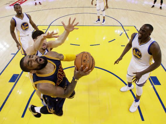 Kyrie Irving has plans to get on the nerves of the three Warriors in this shot (Getty Images).