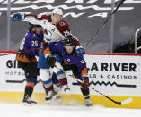 Colorado Avalanche's Nathan MacKinnon gets sandwiched between Arizona Coyotes' Dryden Hunt, right, and Niklas Hjalmarsson during the first period of an NHL hockey game Saturday, Feb. 27, 2021, in Glendale, Ariz. (AP Photo/Darryl Webb)