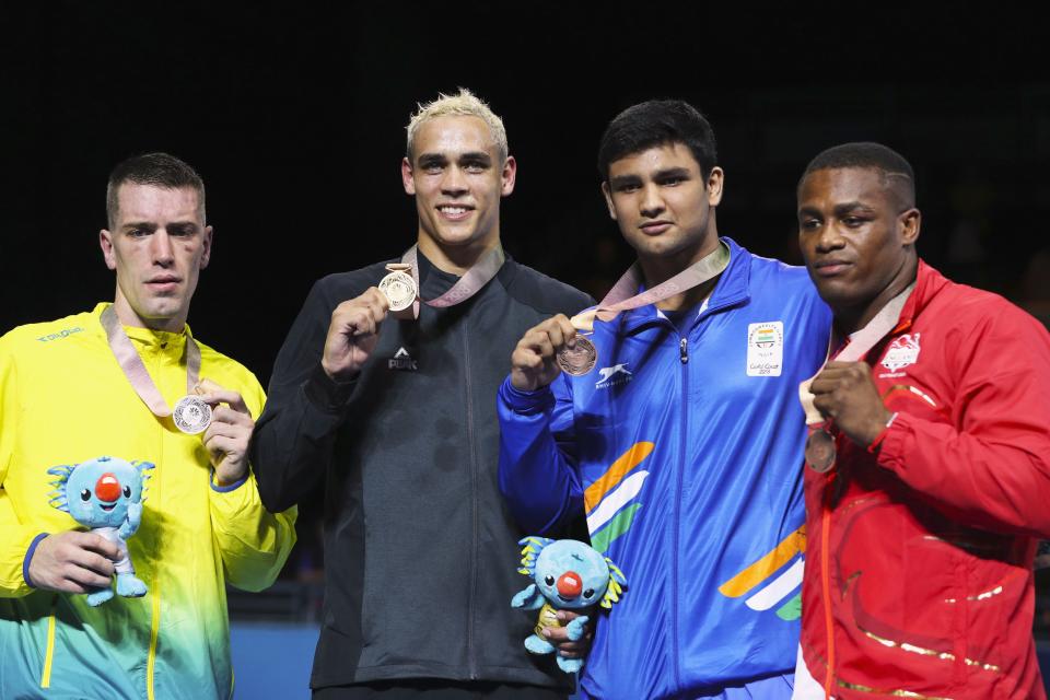 Gold medallist David Nyika of New Zealand, silver medallist Jason Whateley of Australia, bronze medallists Cheavon Clarke of England and Naman Tawar of India. REUTERS/Athit Perawongmetha