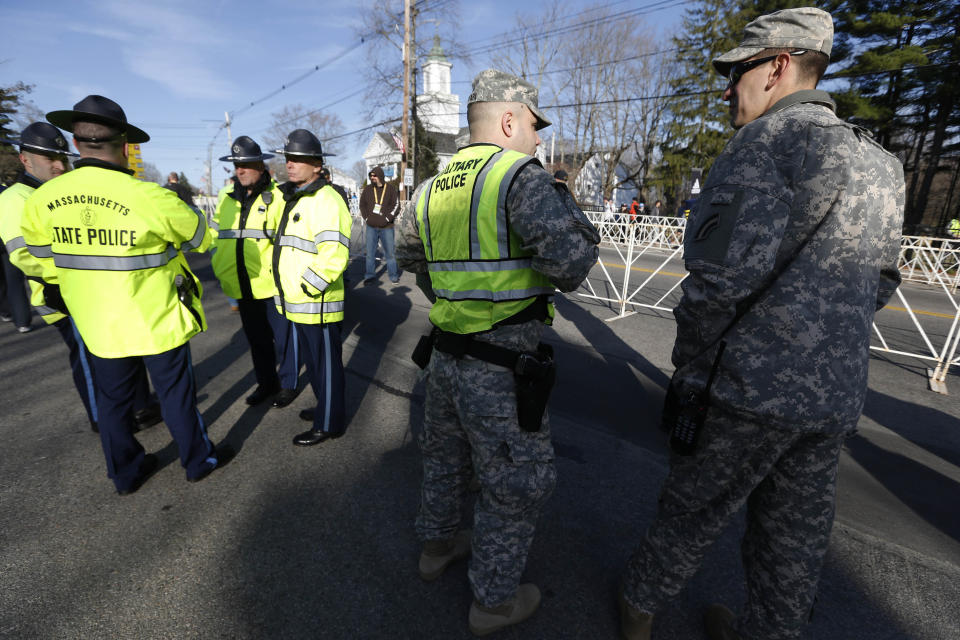 Massachusetts State Police and military police gather before the start of the 118th Boston Marathon Monday, April 21, 2014 in Hopkinton, Mass. (AP Photo/Michael Dwyer)