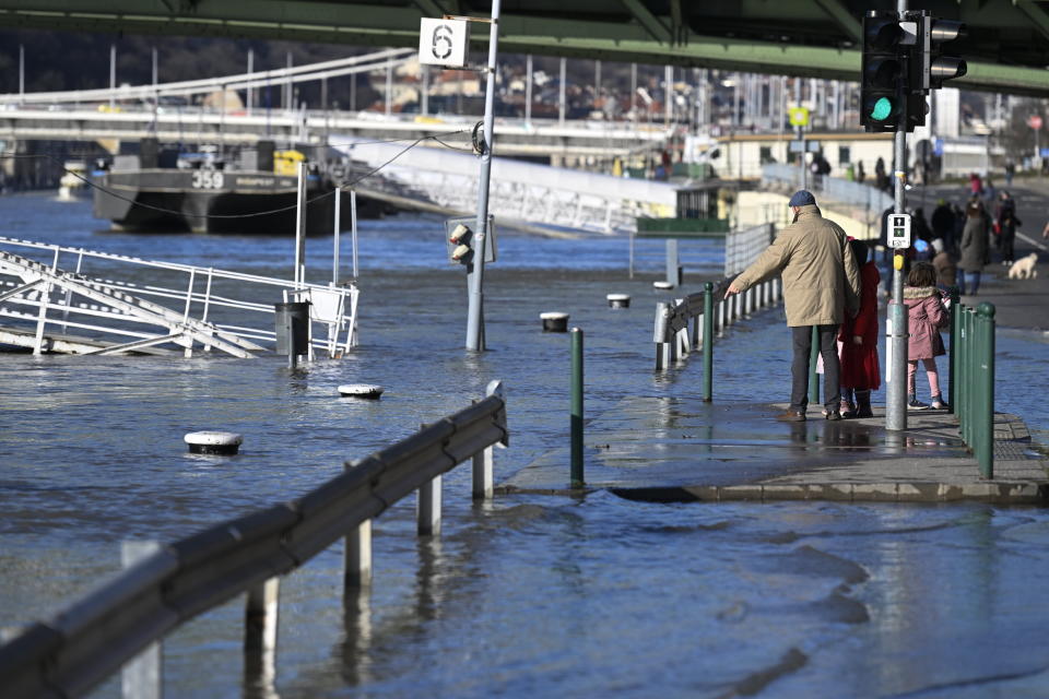 The Sara Salkahazi quay is flooded by the river Danube at Fovam square in downtown Budapest, Hungary, Wednesday, Dec. 27, 2023. Due to the recent rains and snow, the water level of the Danube has risen. (Tamas Kovacs/MTI via AP)