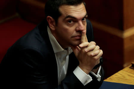 FILE PHOTO: Greek Prime Minister Alexis Tsipras looks on during a parliamentary session before a vote on setting up a special committee which will probe the role of ten politicians in a case which involves alleged bribery by Swiss drugmaker Novartis, in Athens, Greece, February 21, 2018. REUTERS/Alkis Konstantinidis/File Photo