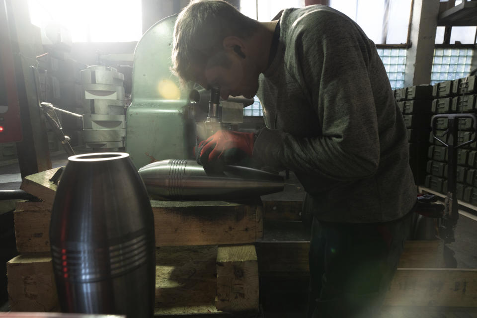 A worker puts serial numbers on the a mortar shell at a factory in Ukraine, on Wednesday, January 31, 2024. (AP Photo/Evgeniy Maloletka)