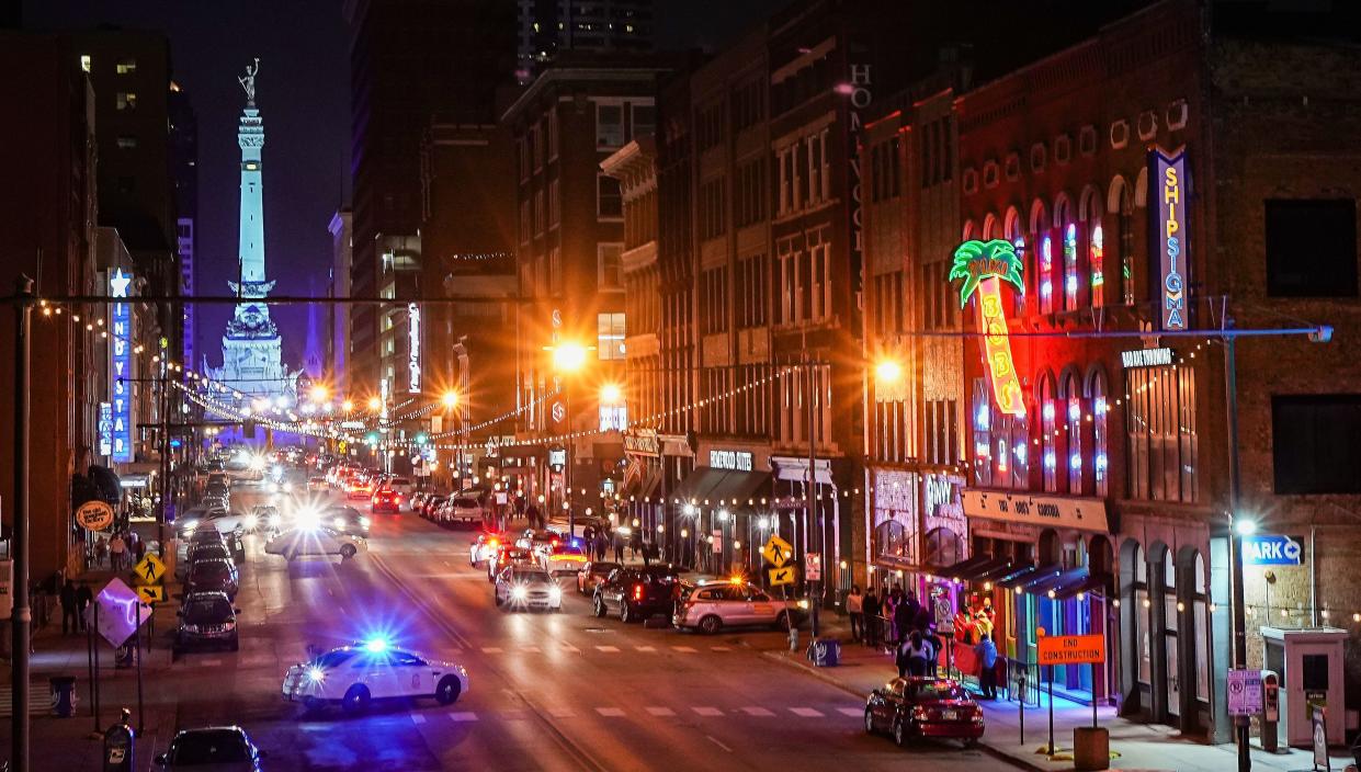 Officers sit outside of a busy bar district Saturday, Jan. 14, 2023 on South Meridian Street in downtown Indianapolis. 