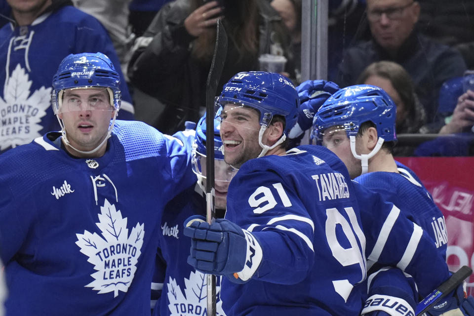 Toronto Maple Leafs players celebrate after a goal by teammate Calle Jarnkrok, right, against the New York Islanders during second-period NHL hockey game action in Toronto, Ontario, Monday, Jan. 23, 2023. (Nathan Denette/The Canadian Press via AP)