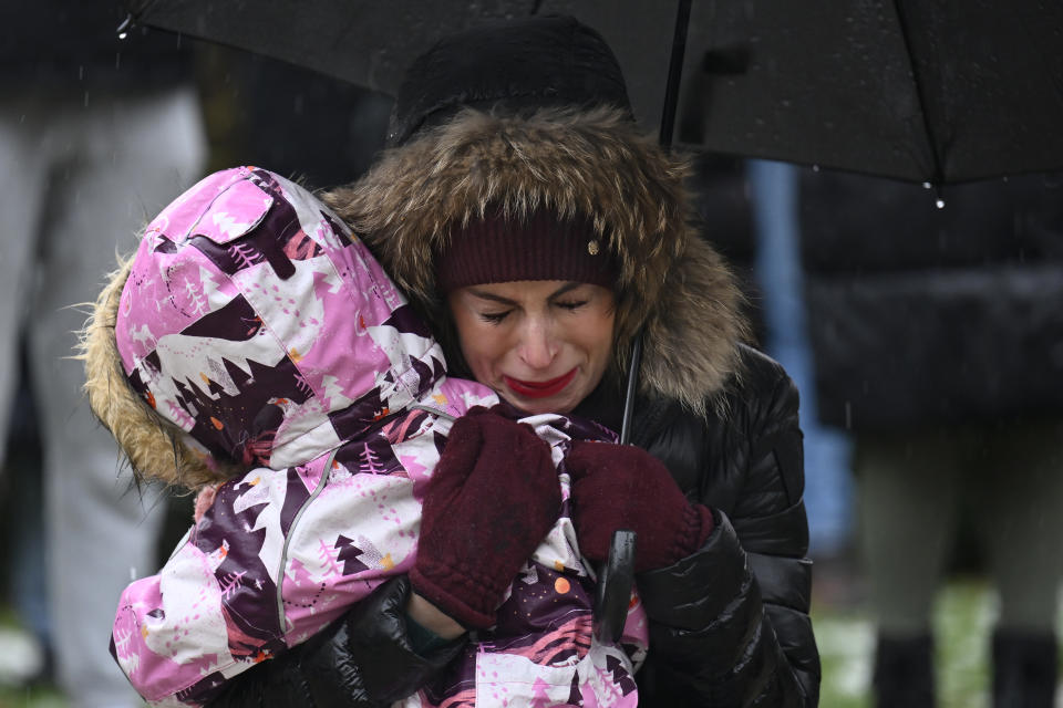 A mourner cries in front of the building of Philosophical Faculty of Charles University in downtown Prague, Czech Republic, Saturday, Dec. 23, 2023. A lone gunman opened fire at a university on Thursday, killing more than a dozen people and injuring scores of people. (AP Photo/Denes Erdos)