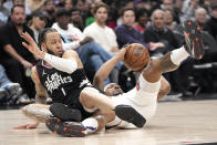 Los Angeles Clippers guard Amir Coffey, left, and Phoenix Suns guard Bradley Beal battle for a loose ball during the first half of an NBA basketball game Wednesday, April 10, 2024, in Los Angeles. (AP Photo/Mark J. Terrill)