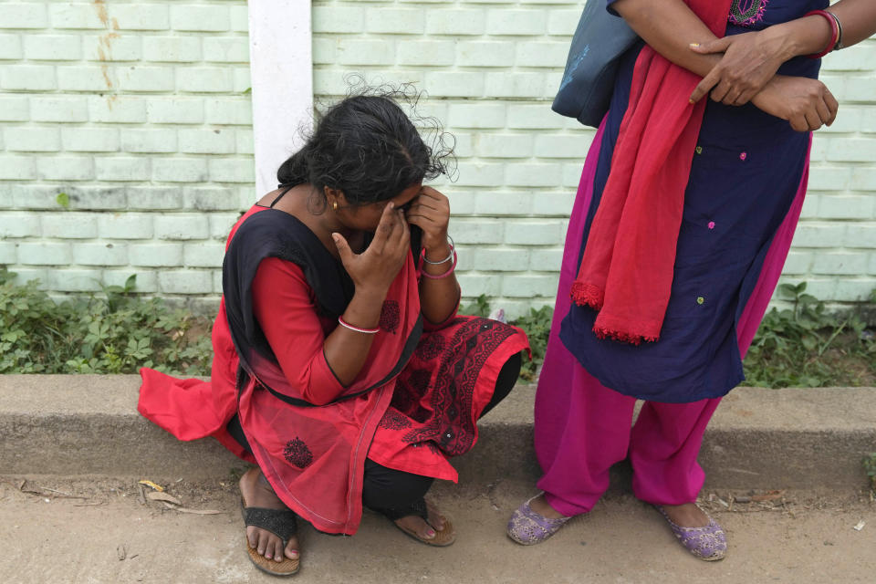 A woman cries while looking for her husband who was traveling in the train that derailed, in Balasore district, in the eastern Indian state of Orissa, Sunday, June 4, 2023. Indian authorities end rescue work and begin clearing mangled wreckage of two passenger trains that derailed in eastern India, killing over 300 people and injuring hundreds in one of the country’s deadliest rail crashes in decades. (AP Photo/Rafiq Maqbool)