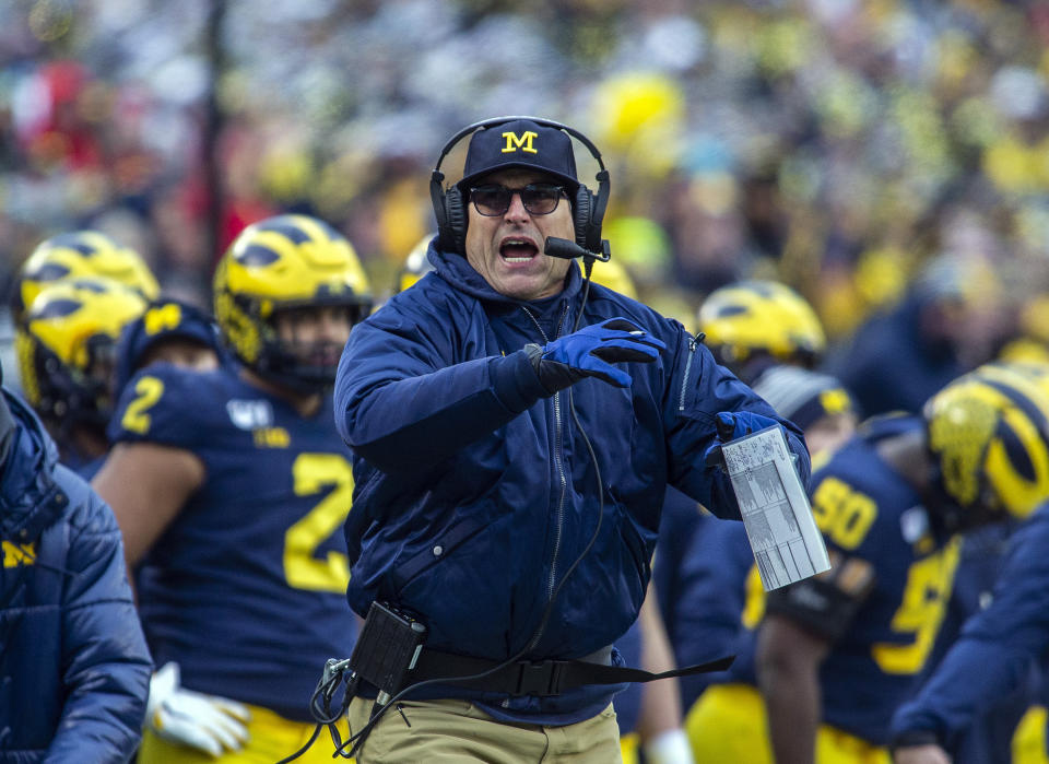 Michigan head coach Jim Harbaugh calls a timeout in the third quarter of an NCAA college football game against Ohio State in Ann Arbor, Mich., Saturday, Nov. 30, 2019. Ohio State won 56-27. (AP Photo/Tony Ding)