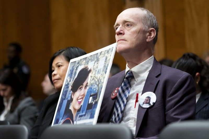 Clariss Moore, L, and Chris Moore hold up a photograph of their daughter, Danielle Moore, who died after Ethiopian Airlines flight 302 crashed minutes after it took off from an Addis Ababa airport during a Senate Homeland Security and Governmental Affairs Subcommittee on Investigations hearing on concerns regarding Boeing's safety standards at the Capitol on Wednesday. Photo by Bonnie Cash/UPI