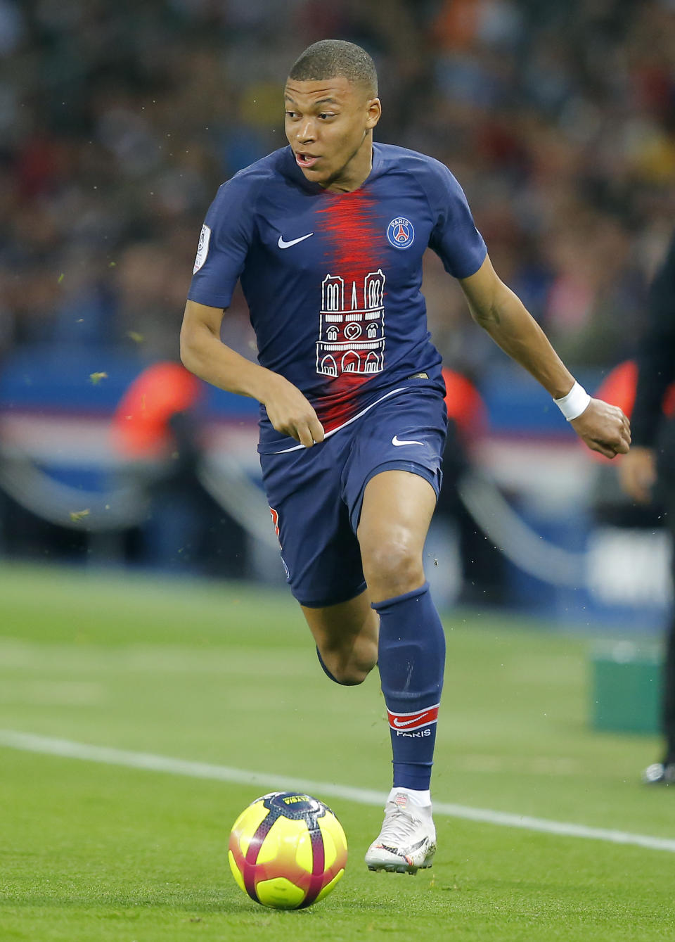 PSG's Kylian Mbappe runs with the ball during the French League One soccer match between Paris-Saint-Germain and Monaco at the Parc des Princes stadium in Paris, Sunday April 21, 2019. (AP Photo/Michel Euler)