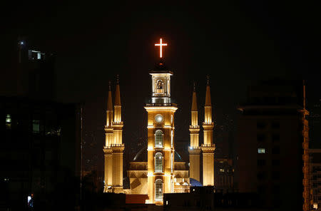 Saint George Maronite Cathedral's cross is lit during the inauguration of its bell tower in downtown Beirut, Lebanon November 19, 2016. REUTERS/Mohamed Azakir