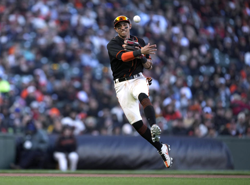 San Francisco Giants shortstop Mauricio Dubon throws to first base for the out on St. Louis Cardinals' Juan Yepez during the seventh inning of a baseball game Saturday, May 7, 2022, in San Francisco. (AP Photo/Tony Avelar)