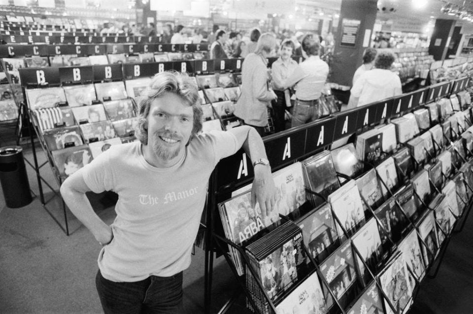 Richard Branson is seen here in July 1979 in his London Virgin Mega Store Record Shop with records and tapes in the background.