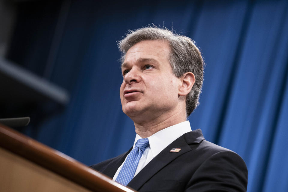 FBI Director Christopher Wray speaks during a virtual news conference at the Department of Justice, Wednesday, Oct. 28, 2020 in Washington. The Justice Department has charged eight people with working on behalf of the Chinese government to locate Chinese dissidents and political opponents living in the U.S. and coerce them into returning to China. Five of the eight were arrested Wednesday morning. (Sarah Silbiger/Pool via AP)