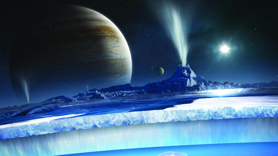  Illustration of Europa's surface and water under it's ice crust, with the Europa clipper flying ahead and Jupiter in the background. 