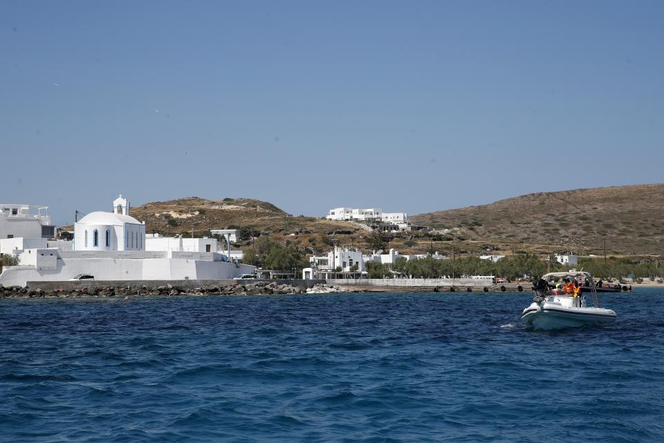 In this Monday, May 25, 2020 photo, medical staff in a dinghy leaves from the Aegean Sea island of Milos to Sikinos island, Greece. Using dinghies, a GPS, and a portable refrigerator, state doctors have launched a COVID-19 testing drive on islands in the Aegean Sea ahead of the holiday season. The first round of testing was completed after trips to the islands of Milos, Kimolos, Folegandros, and Sikinos. (AP Photo/Thanassis Stavrakis)