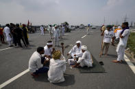 Protesting farmers gather at Singhu, outskirts of New Delhi, India, Monday, Sept.27, 2021. Thousands of Indian farmers Monday blocked traffic on major roads and railway tracks outside of the nation's capital, calling on the government to rescind agricultural laws that they say will shatter their livelihoods. The farmers called for a nation-wide strike to mark one year since the legislation was passed, marking a return to protests that began over a year ago. (AP Photo/Manish Swarup)