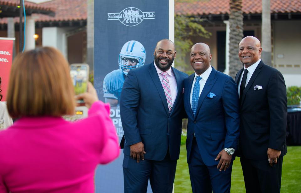 Former NFL quarterbacks Donovan McNabb (L-R), Rodney Peete and Warren Moon pose for a picture during the red carpet arrival at the National Quarterback Club Ceremony at the Scottsdale Resort at McCormick Ranch.