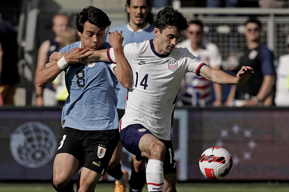 Uruguay forward Facundo Pellistri (8) and USA midfielder Luca de la Torre (14) chase the ball during the second half of an international friendly soccer match Sunday, June 5, 2022, in Kansas City, Kan. The match ended in a 0-0 tie. (AP Photo/Charlie Riedel)